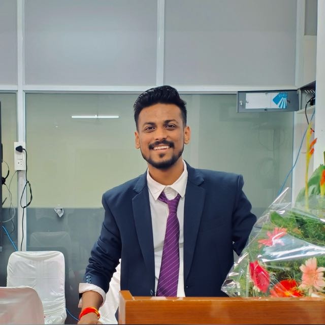 Vaibhav Barde smiling in a formal suit and tie